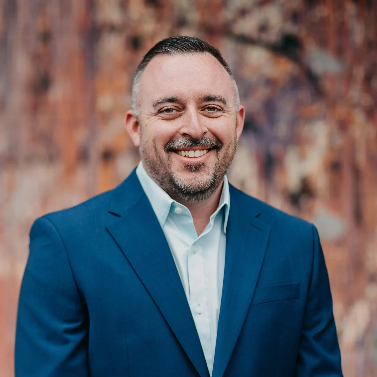 Mitchell Sawin smiling in a navy jacket